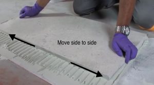 Moving tile side to side to bed it