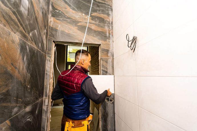 man installing tile